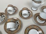 a lot of cups and saucers on the table