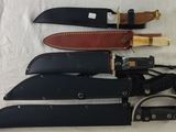 several knives are lined up on a white surface with a leather strap