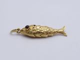 an image of a gold fish charm on a white background