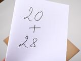 a person holding a piece of paper with the word love and peace written on it
