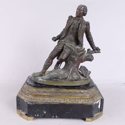 statue en bronze représentant un homme avec un chien, posée sur un socle en marbre