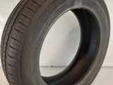 a close up of a tire on a white surface with a hand holding it