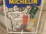 a sign that says michel on it in front of a window