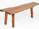 a wooden bench that is sitting on a white surface