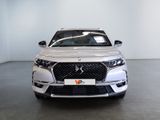 the front view of a white car in a white room