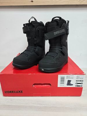 the box is full of a pair of black snow boots