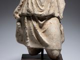an ancient statue of a woman draped in a cloth