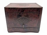 an old wooden box sitting on top of a white surface