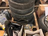 a pile of old tires and other items on a pallet