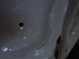 a close up of a white porcelain object on a table