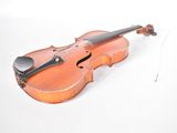 a violin that is sitting on a white surface