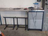 a desk with a computer on it in a garage