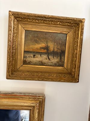 two framed pictures hanging on the wall above a mirror