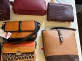 a lot of purses on a table in a room