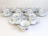 a lot of cups and saucers sitting on a table