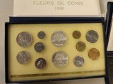 several different types of coins are displayed in a display case