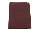 a burgundy leather notebook with a gold zipper closure