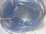 an image of a coil of blue tubs on a white surface