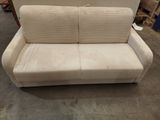 an image of a white couch in a warehouse