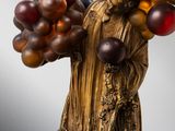 statue of a woman holding a bunch of balloons on a stick