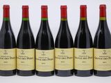 six bottles of red wine lined up in a row