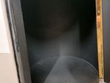 a black cabinet with a door open on the floor