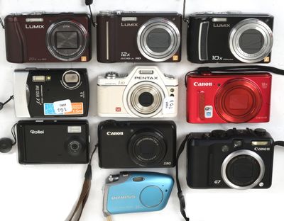 many different types of digital cameras on a white surface