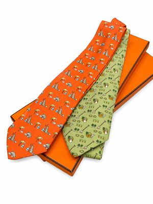 three ties are stacked on top of each other on a white surface