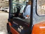an orange forklift truck parked in a warehouse