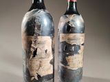 two bottles of wine sitting next to each other on a table