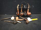 many different types of pipe holders on the table