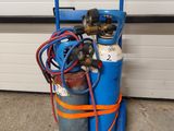 a blue cart with two cylinders and a hose
