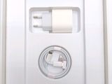 a white box with a charger and a cable in it