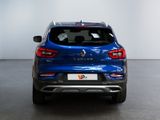 the rear end of a blue car parked in a garage