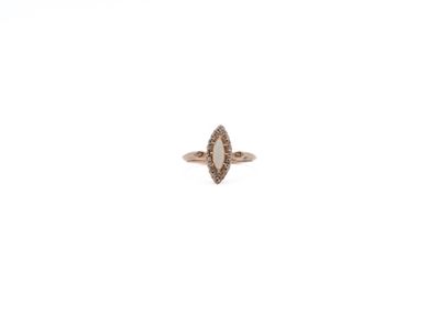 a close up of a diamond ring on a white surface