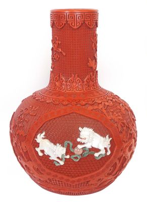 a red vase with a picture of two dogs on it