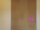 a cork board on the wall in a room