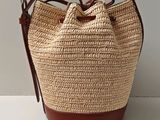 beige and brown straw bag with brown leather handles