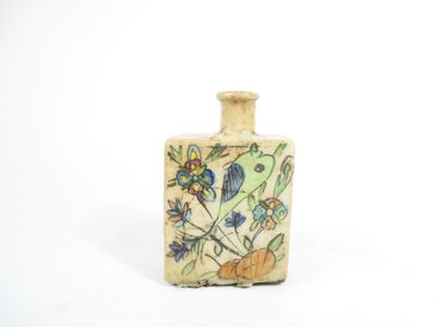 a small ceramic bottle with a floral design on it