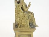 bronze figurine of a woman sitting on a throne reading a book