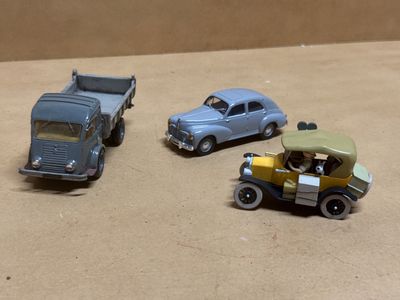 trois voitures jouets qui sont assises l'une à côté de l'autre