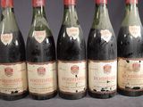 six bottles of wine are lined up in a row on a table