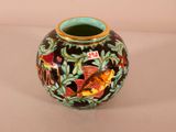 a vase with a design on it sitting on a table