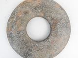 a stone donut that is sitting on a white surface