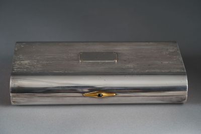 a silver box with a gold decoration on top of it