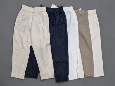 three pairs of men ' s pants on a gray background