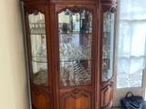 a china cabinet in the corner of the room
