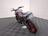 a motorcycle that is sitting on a checkered floor