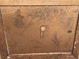 a picture of an old wooden cabinet with some writing on it