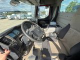 a man that is driving a truck with a steering wheel